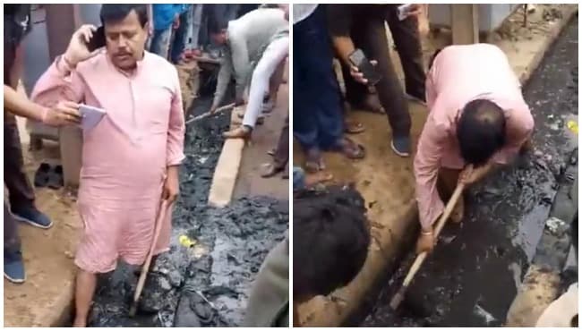 जब कीचड़ साफ़ करने नाली में उतर गए मंत्री, सफाई कर्मियों पर गिरी गाज